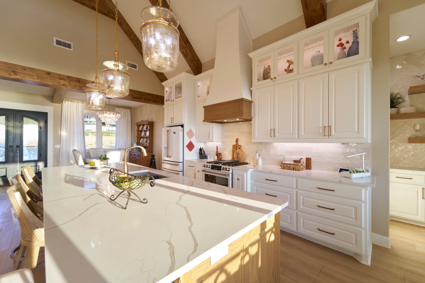 Bright custom kitchen showcasing designer cabinetry, premium countertops, and timeless interior design.